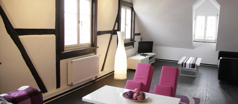 living room image, a room with pink chairs and a white table